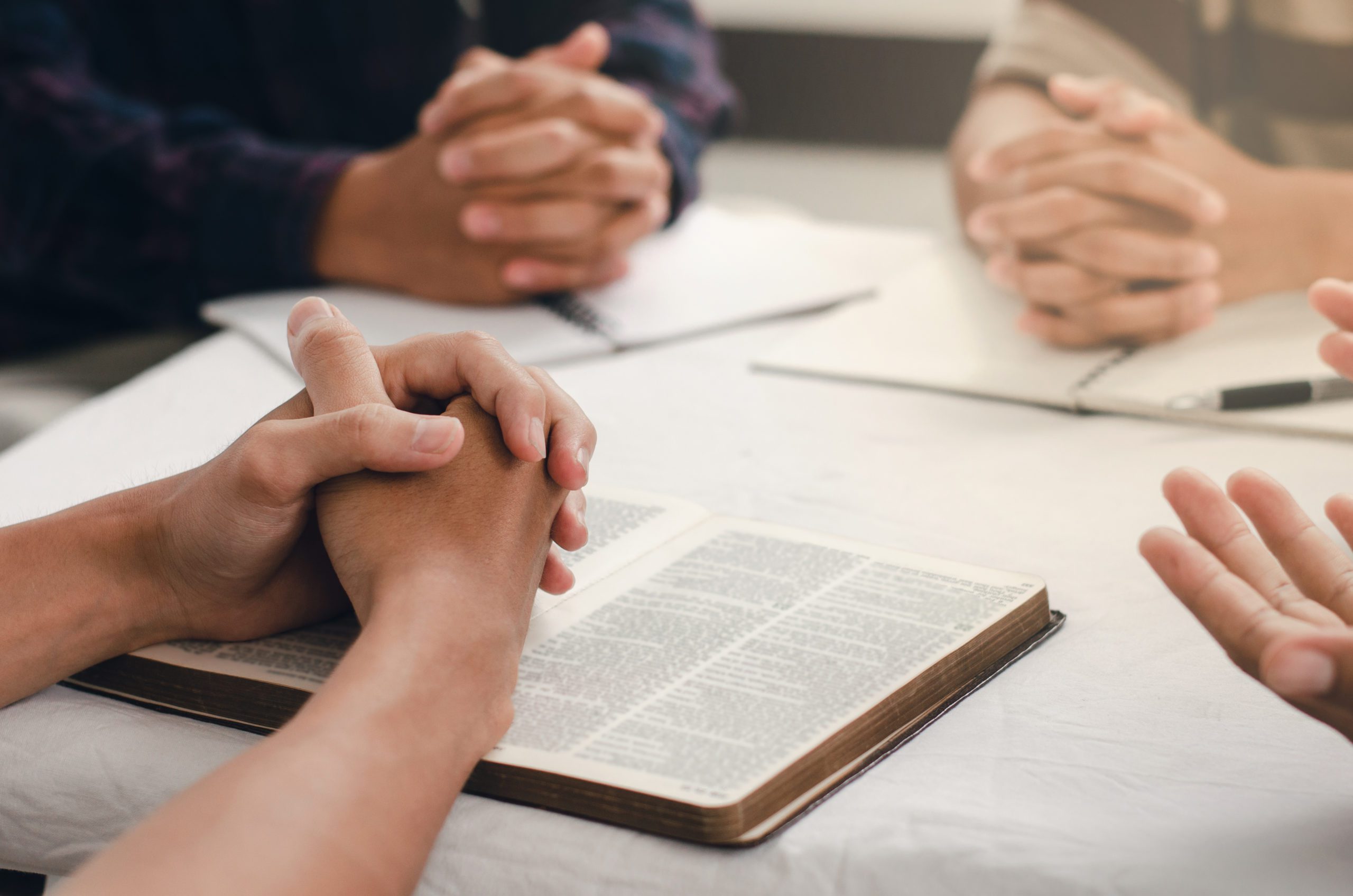 Christians Gather Sit And Pray For Blessings From God. With Fait A woman and two men were studying and reading the Bible. That is Christian love