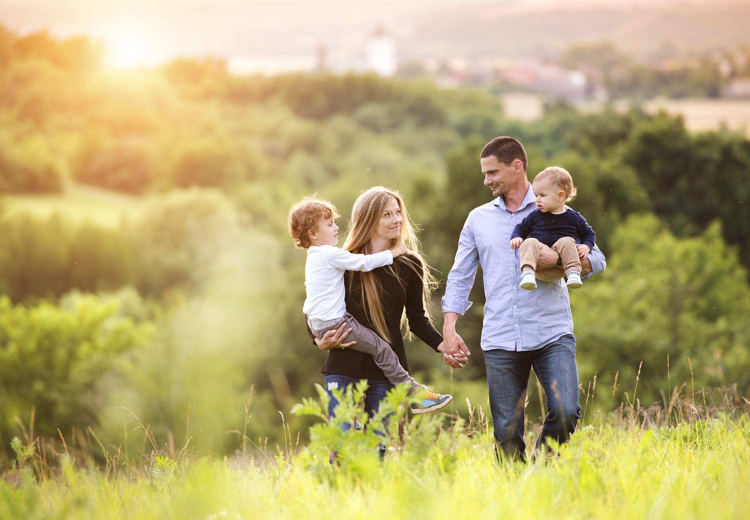 Happy family Happy young family spending time together outside in green nature.